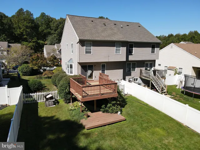 an aerial view of a house with garden space and a patio