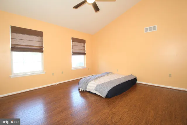 a spacious bedroom with a bed and a window