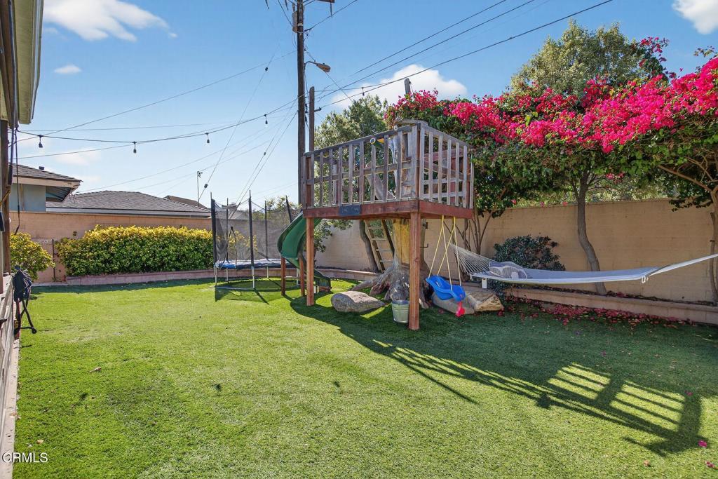 525 North M Street Oxnard, CA 93030 - Photo 30 of 38 a view of an house with swimming pool and a yard