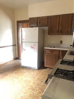 a kitchen with a refrigerator and a stove