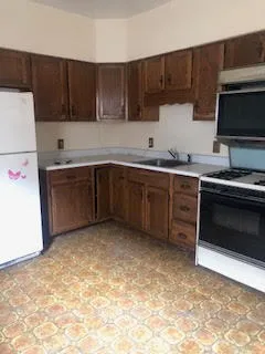 a kitchen with stainless steel appliances granite countertop a stove top oven a sink dishwasher and a microwave oven on the blue kitchen countertops