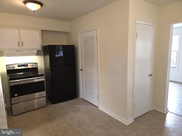 a kitchen with a refrigerator and a stove