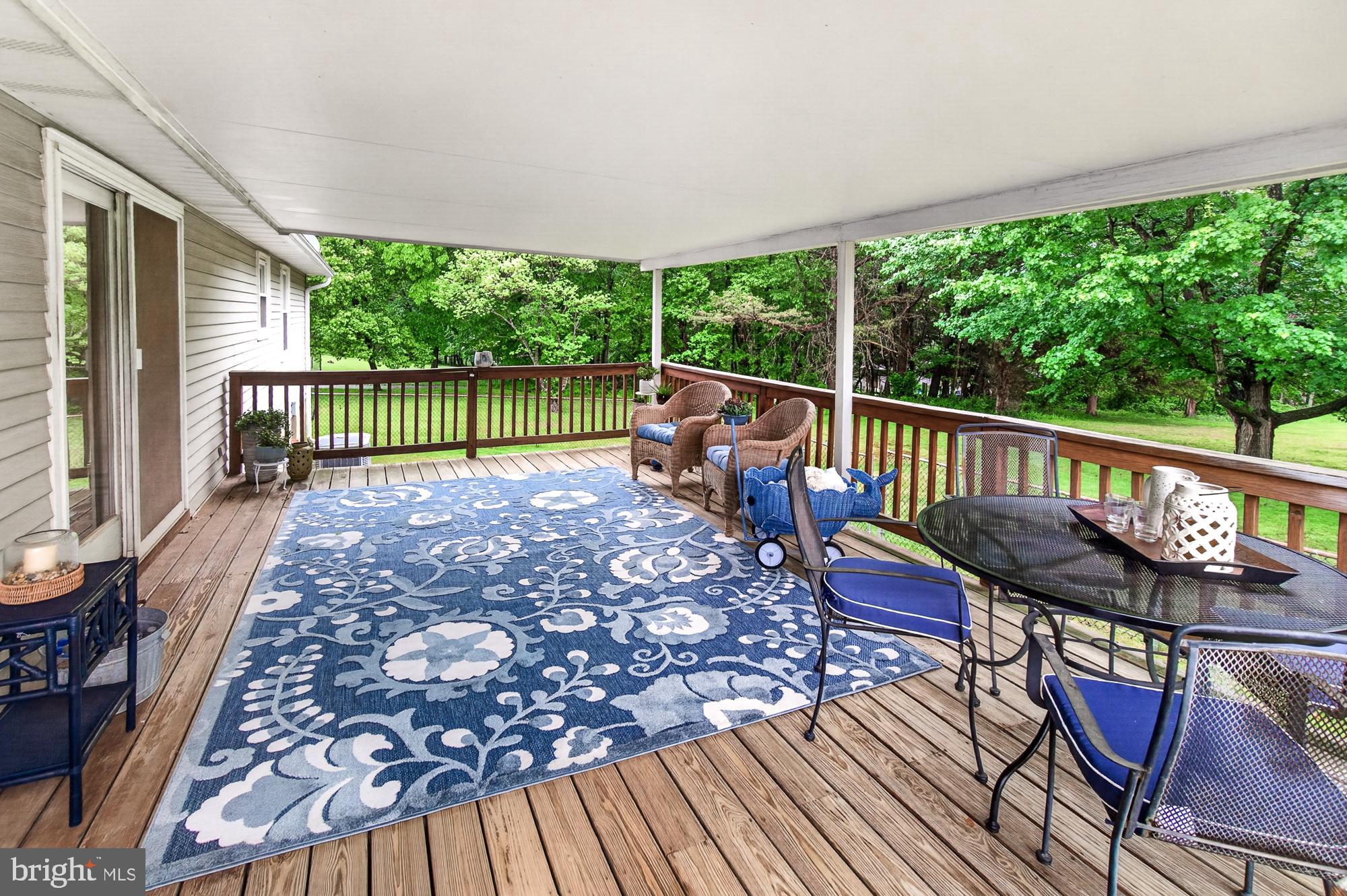 5601 Woodville Road Mount Airy, MD 21771 - Photo 15 of 54 a view of a chairs and table on the wooden deck