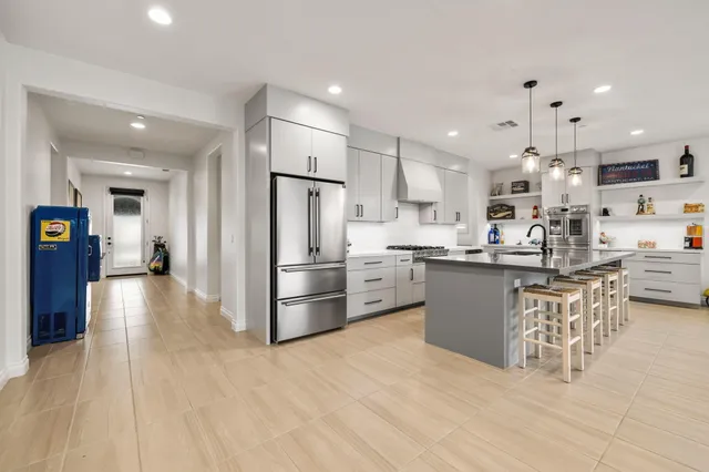 a living room with furniture a large window and a fireplace