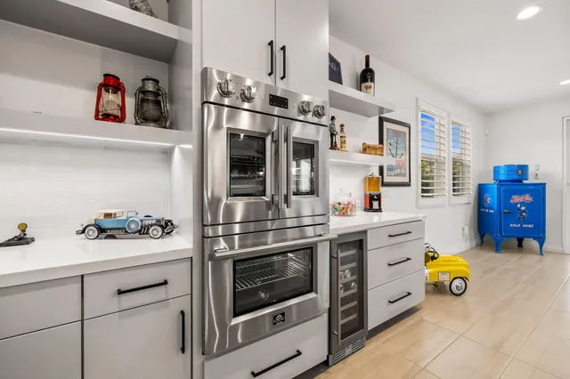 a living room with furniture fireplace and a large window