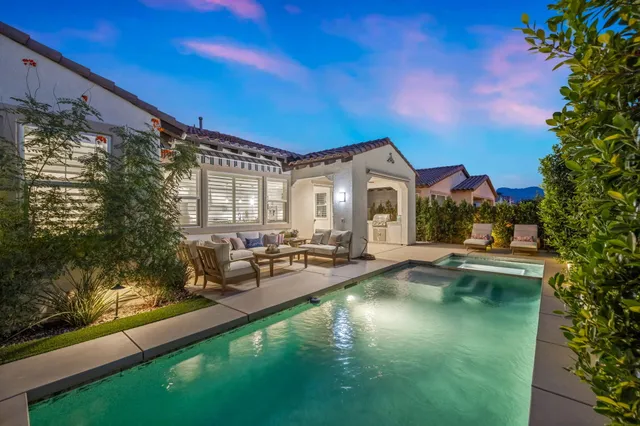 a view of a swimming pool with an outdoor seating and a yard