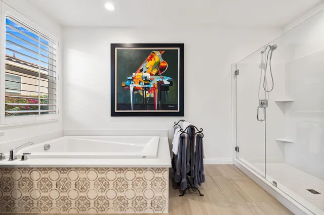 a view of a swimming pool with lounge chairs in patio