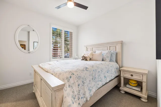 a view of a patio with couches table and chairs with potted plants and a big yard