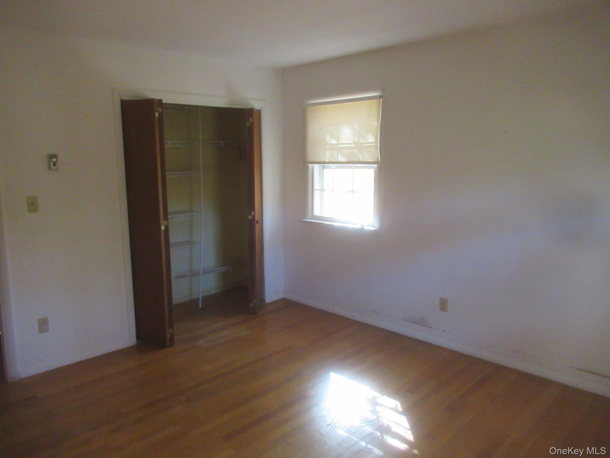 77 Brothers Road Wappingers Falls, NY 12590 - Photo 13 of 21 an empty room with wooden floor and windows
