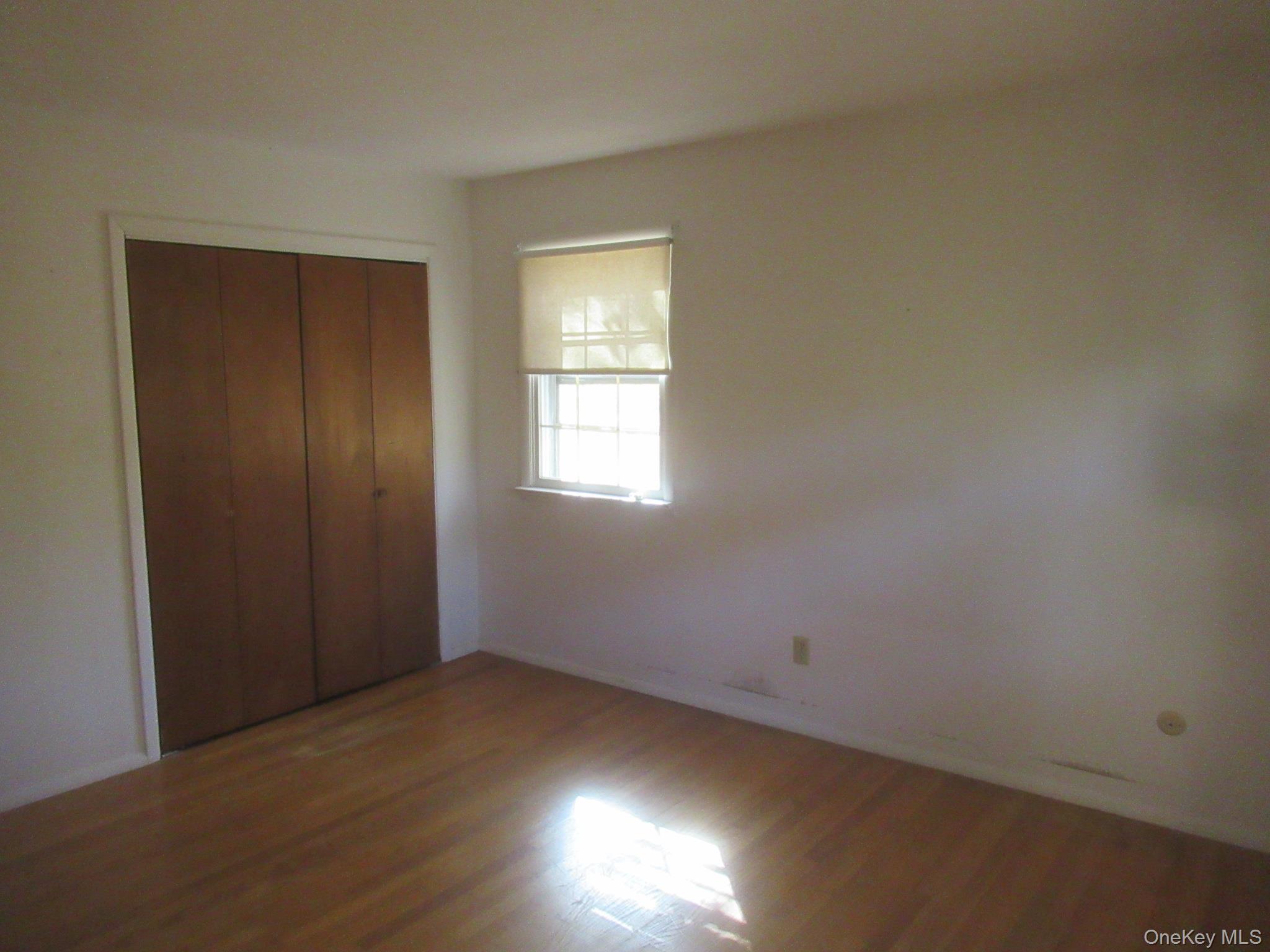 77 Brothers Road Wappingers Falls, NY 12590 - Photo 16 of 21 an empty room with wooden floor and windows