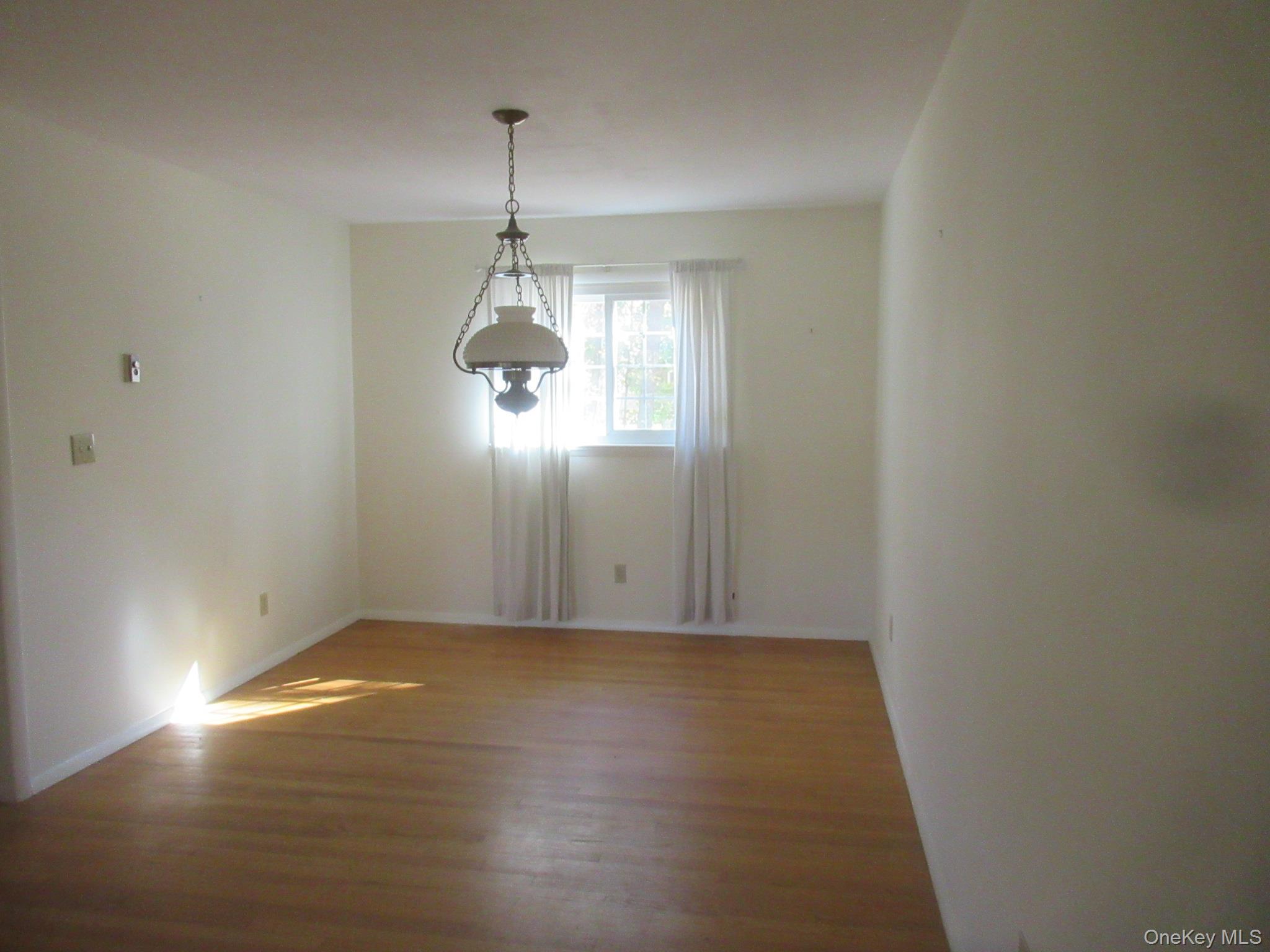 77 Brothers Road Wappingers Falls, NY 12590 - Photo 6 of 21 a view of a room with wooden floor chandeliers and kitchen