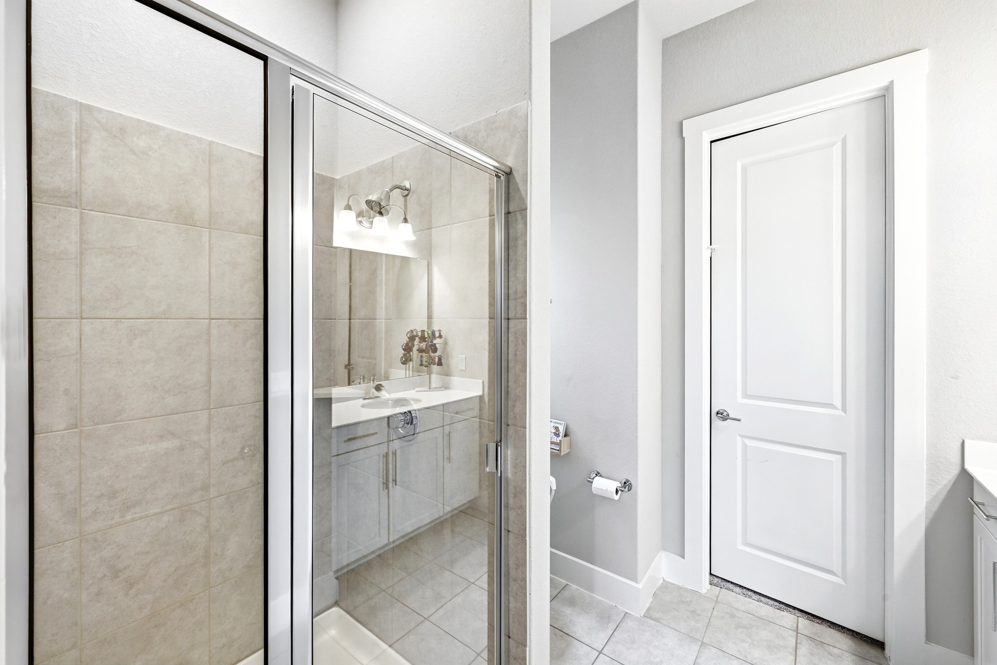 9008 Harper Rae Drive Austin, TX 78717 - Photo 33 of 39 Glass-enclosed shower with tiled walls and flooring