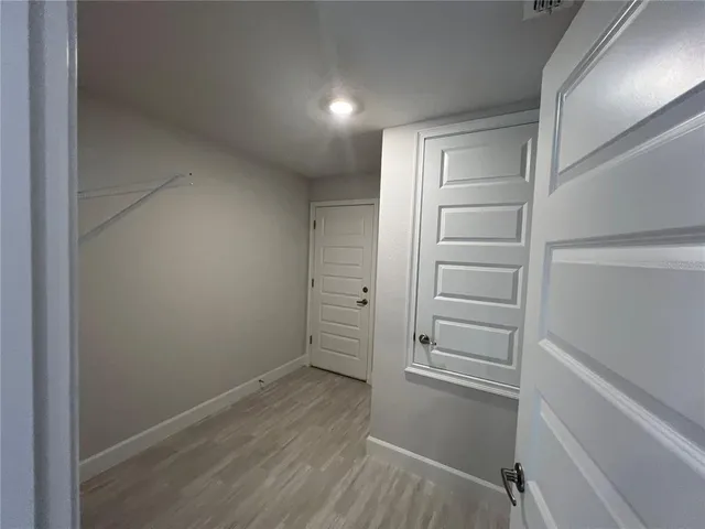 a view of walk in closet with empty racks