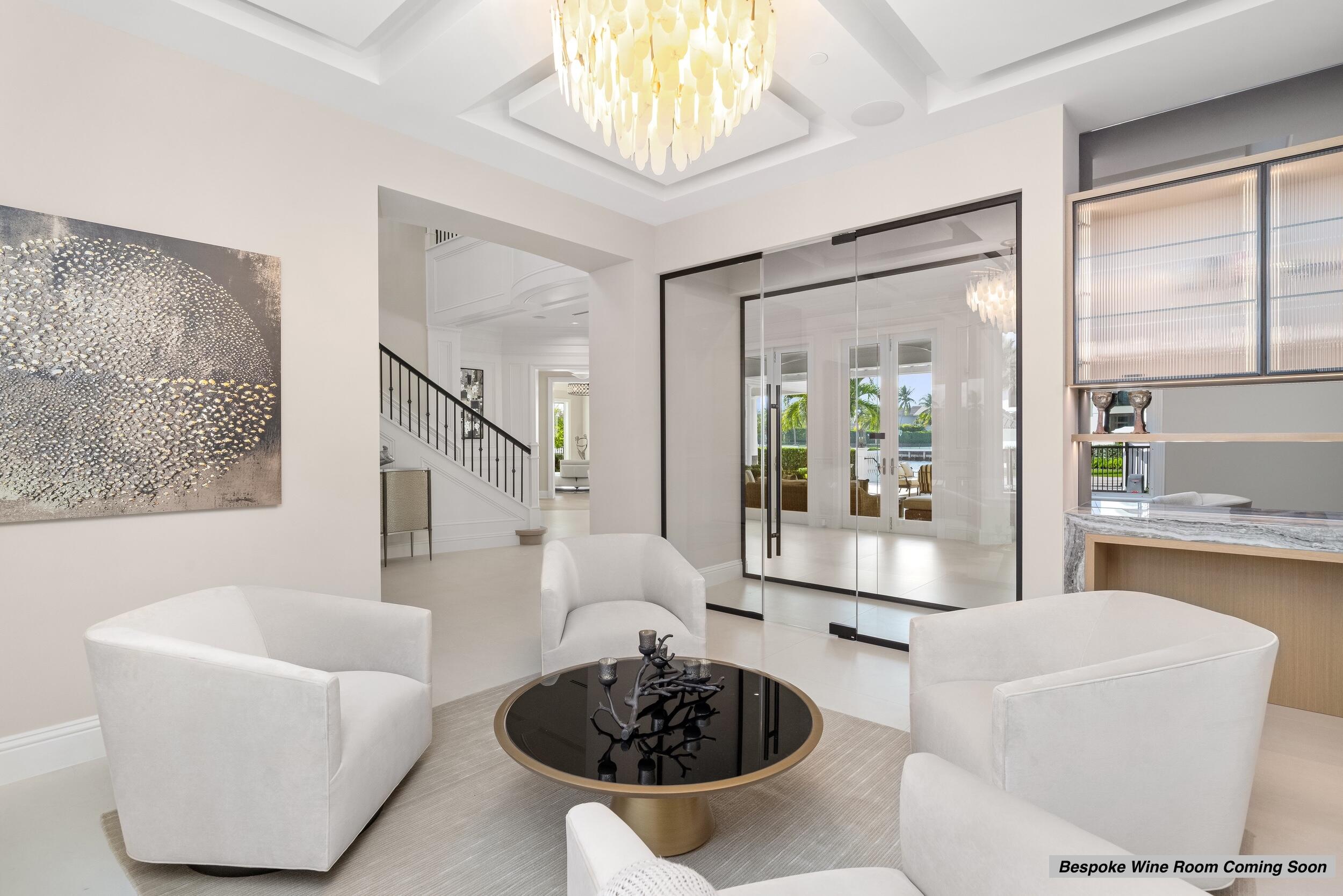 2989 Spanish River Road Boca Raton, FL 33432 - Photo 12 of 130 a living room with furniture a chandelier and a large window
