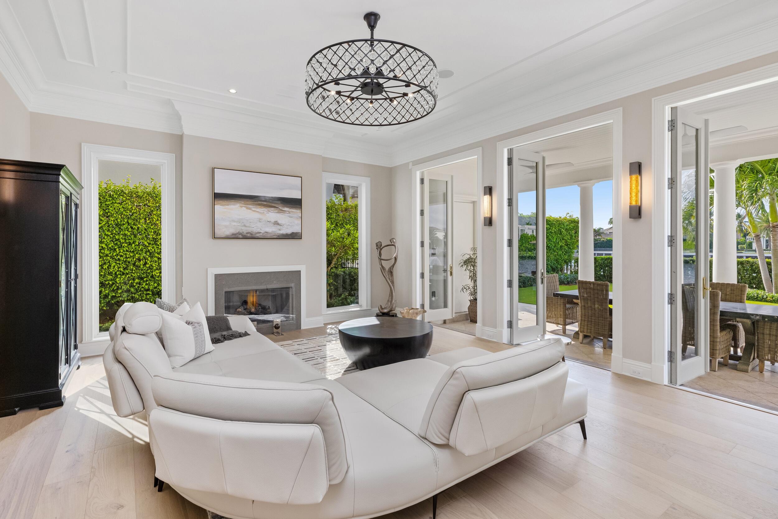 2989 Spanish River Road Boca Raton, FL 33432 - Photo 64 of 130 a living room with furniture chandelier and a fireplace
