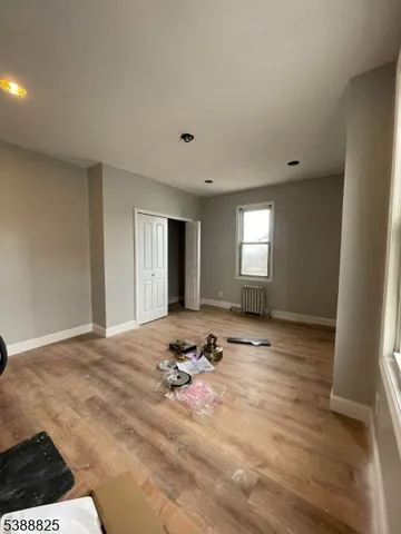 a view of empty room with window and fireplace
