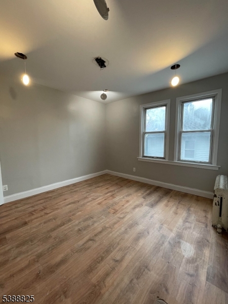 66 Winant Avenue Ridgefield Park, NJ 07660 - Photo 14 of 16 an empty room with wooden floor and windows