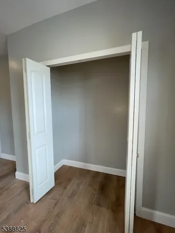 an empty room with wooden floor