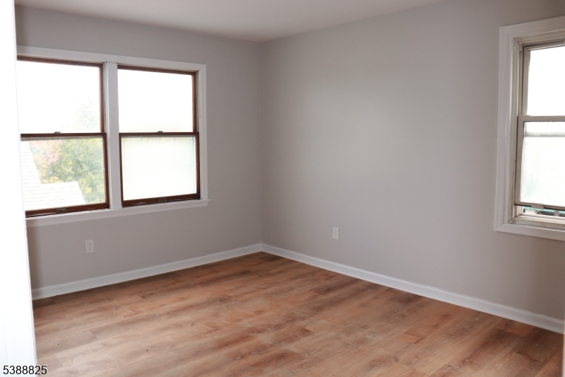 66 Winant Avenue Ridgefield Park, NJ 07660 - Photo 3 of 16 an empty room with wooden floor and windows