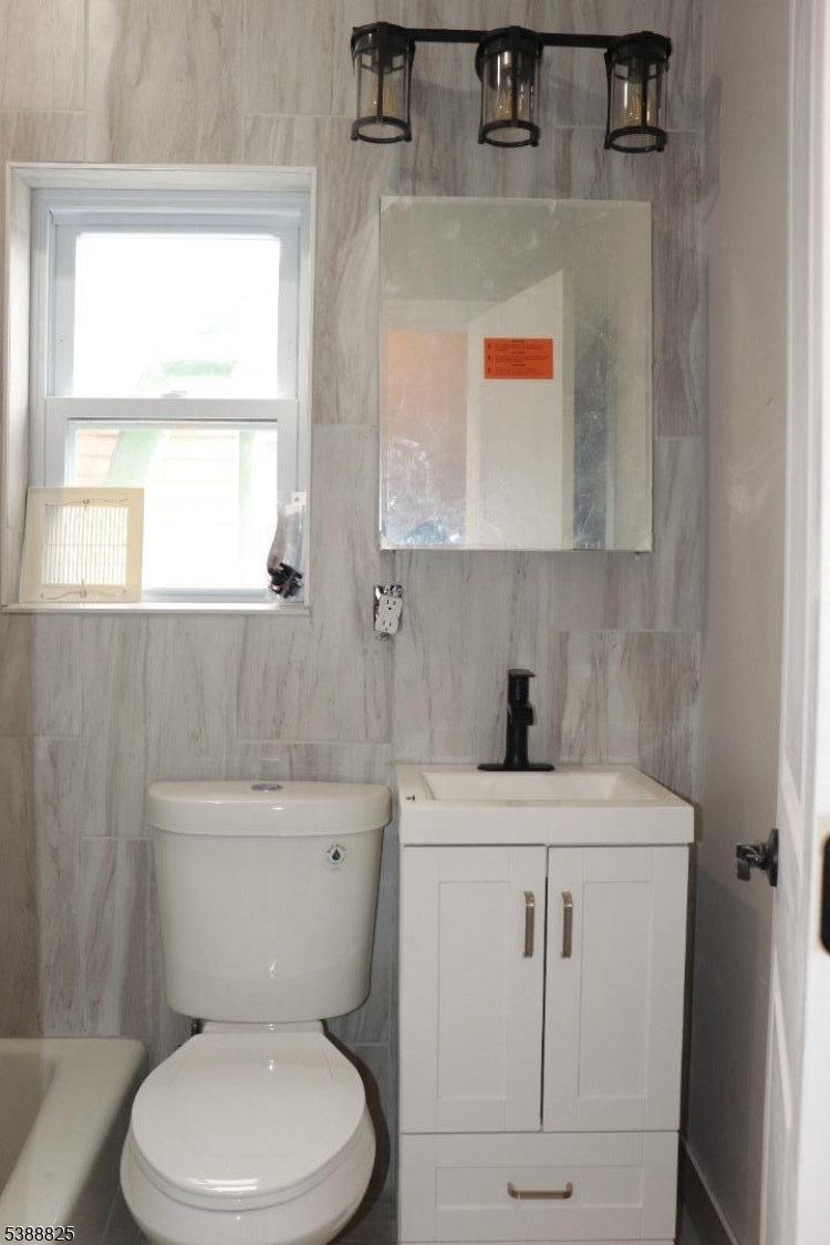 66 Winant Avenue Ridgefield Park, NJ 07660 - Photo 5 of 16 a bathroom with a sink a toilet and a window