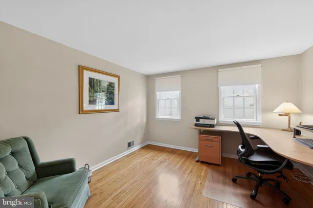 a view of a livingroom with workspace and a couch