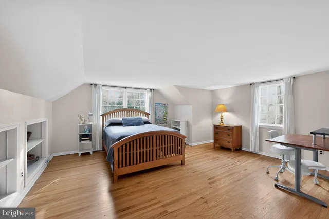 a bedroom with furniture and a window