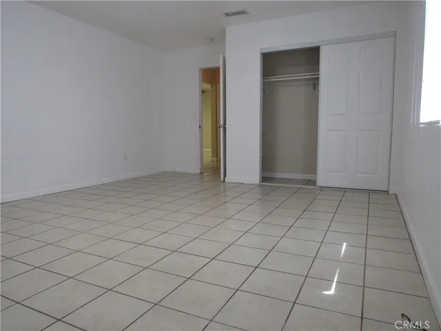 a view of a chairs and table in patio with a fire pit