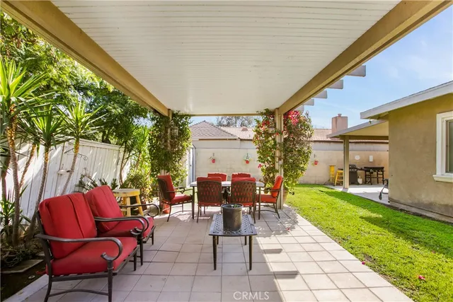 a view of a porch with furniture and garden