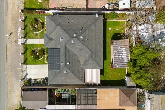 an aerial view of residential houses with outdoor space and swimming pool