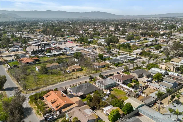 a porch with a table and chairs under an umbrella