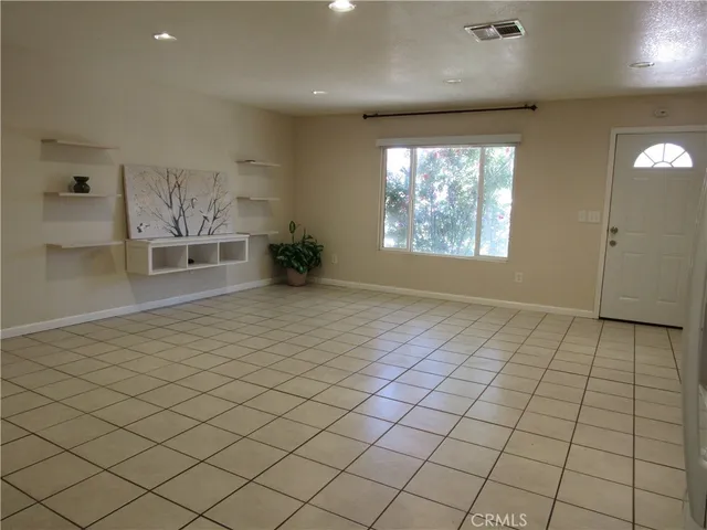 an empty room with windows and mirror