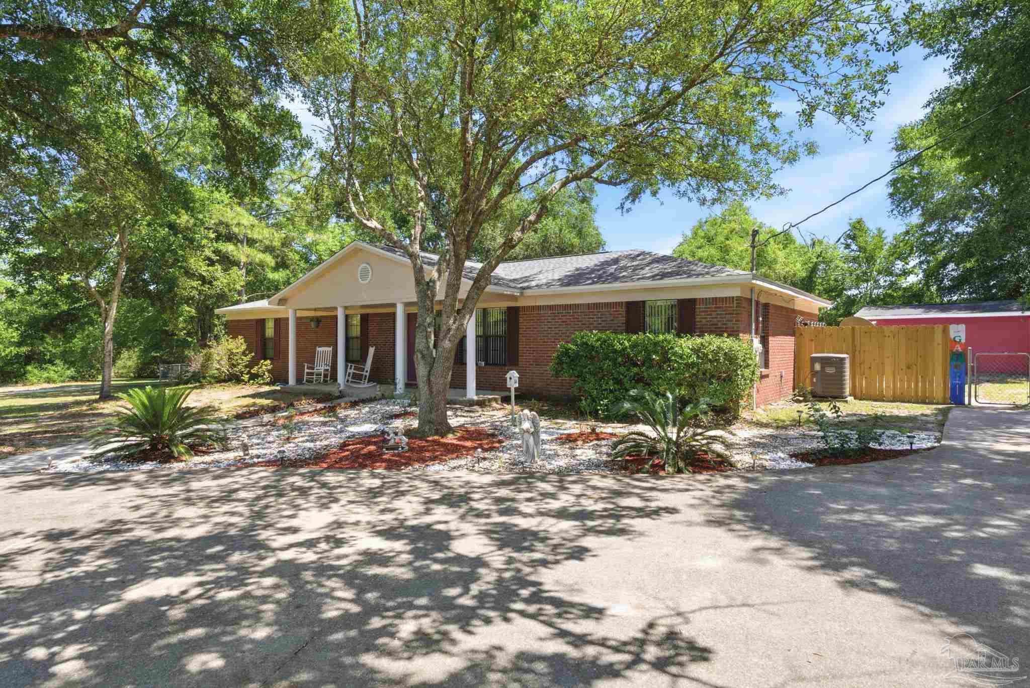 5121 Keyser Mill Road Baker, FL 32531 - Photo 2 of 52 a front view of a house with garden
