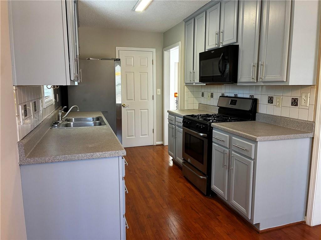 337 Madison Avenue Hampton, GA 30228 - Photo 9 of 32 a kitchen with a sink stove and microwave