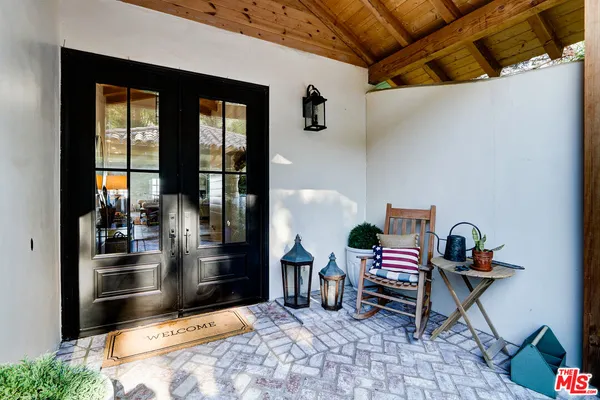 a balcony with table and chairs