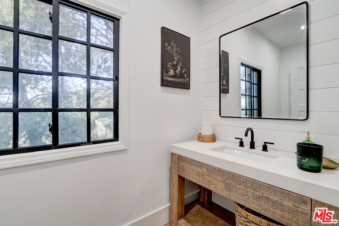 456 McKnight Road Newbury Park, CA 91320 - Photo 28 of 75 a bathroom with a sink and a mirror