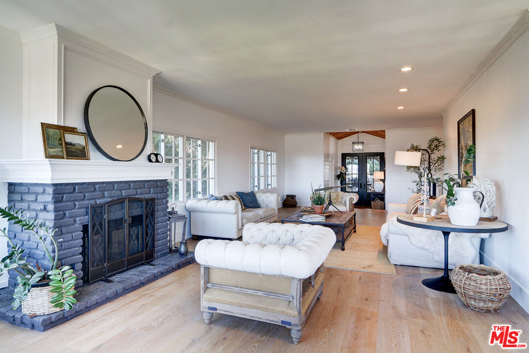 456 McKnight Road Newbury Park, CA 91320 - Photo 33 of 75 a living room with furniture a fireplace and a potted plant