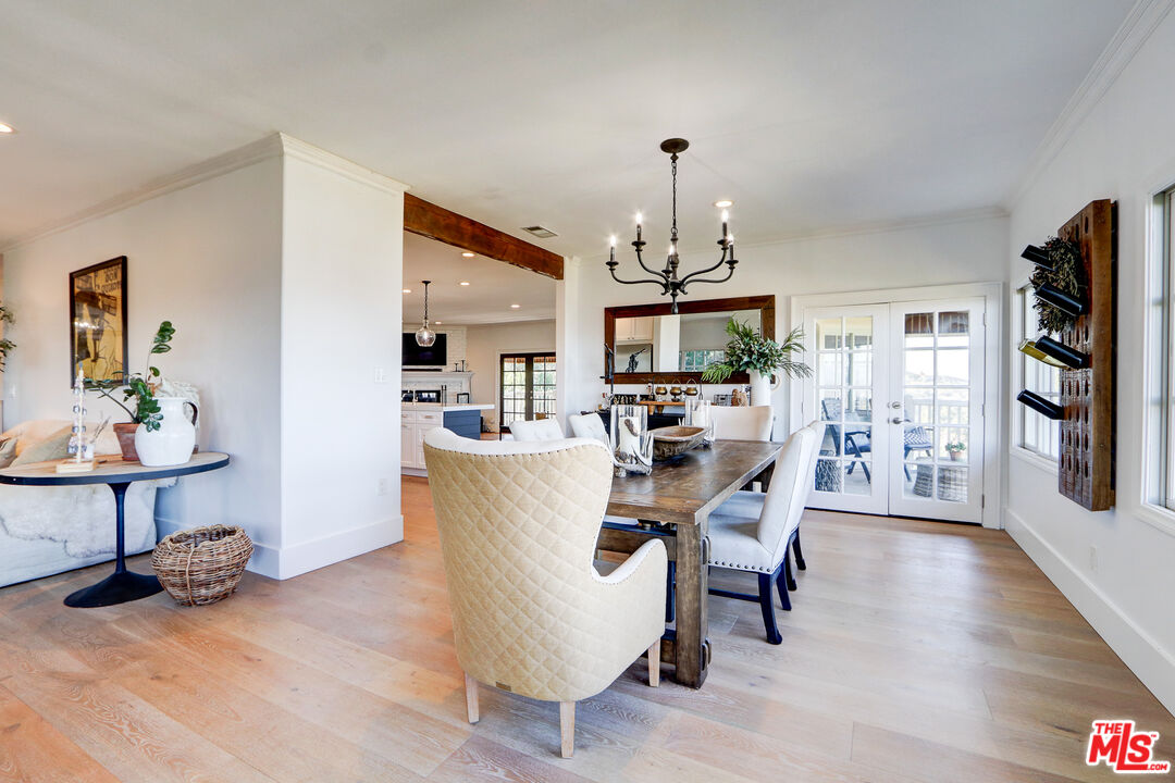 456 McKnight Road Newbury Park, CA 91320 - Photo 35 of 75 a view of a dining room with furniture a chandelier and wooden floor