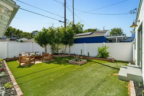 a view of a house with backyard and sitting area