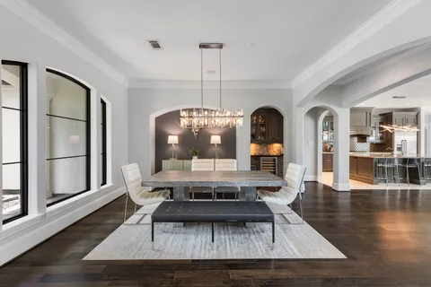 a kitchen with stainless steel appliances granite countertop a sink and cabinets with wooden floor