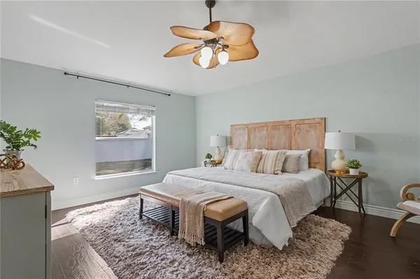 an empty room with wooden floor and outdoor view