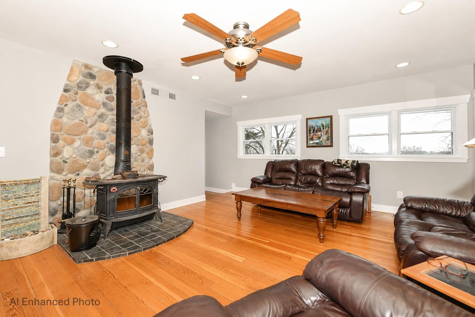 4222 Maple Drive Delavan, WI 53115 - Photo 8 of 42 Vermont casting wood burner adds a cozy touch to your light and bright great room with hardwood floors.