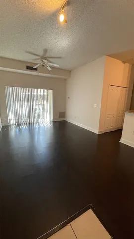 a view of room with hardwood floor and ceiling fan