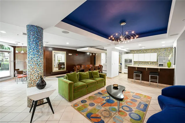 a living room with furniture and a chandelier