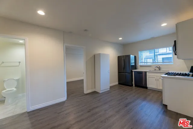 a kitchen with stainless steel appliances a refrigerator and a stove top oven