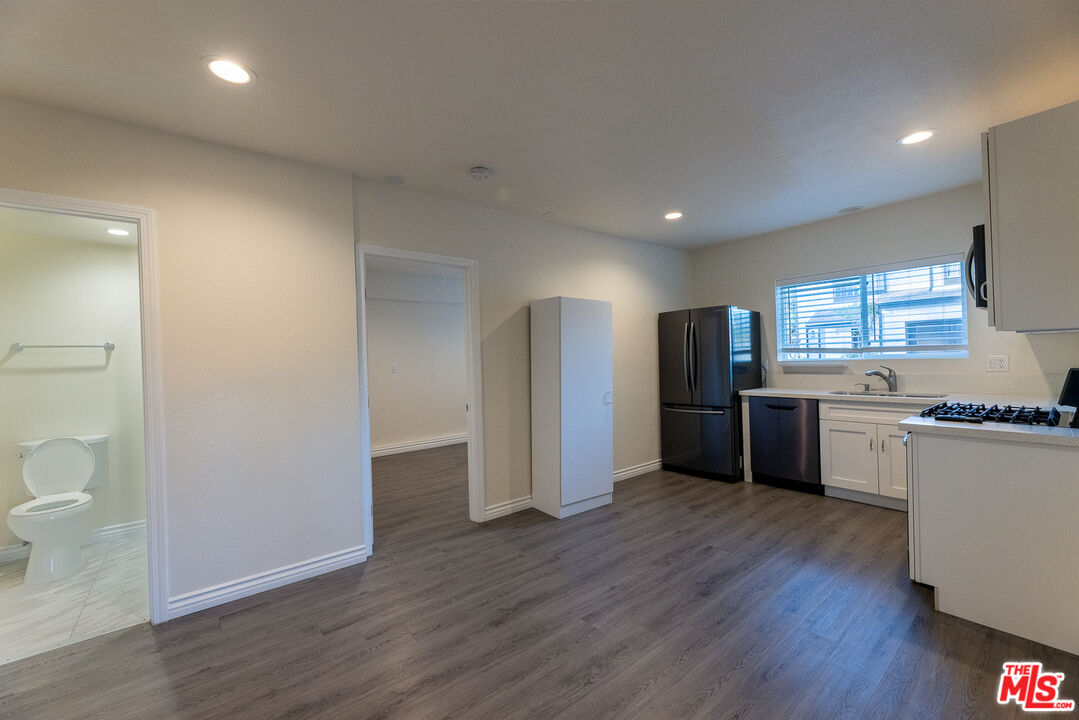 a kitchen with stainless steel appliances a refrigerator and a stove top oven