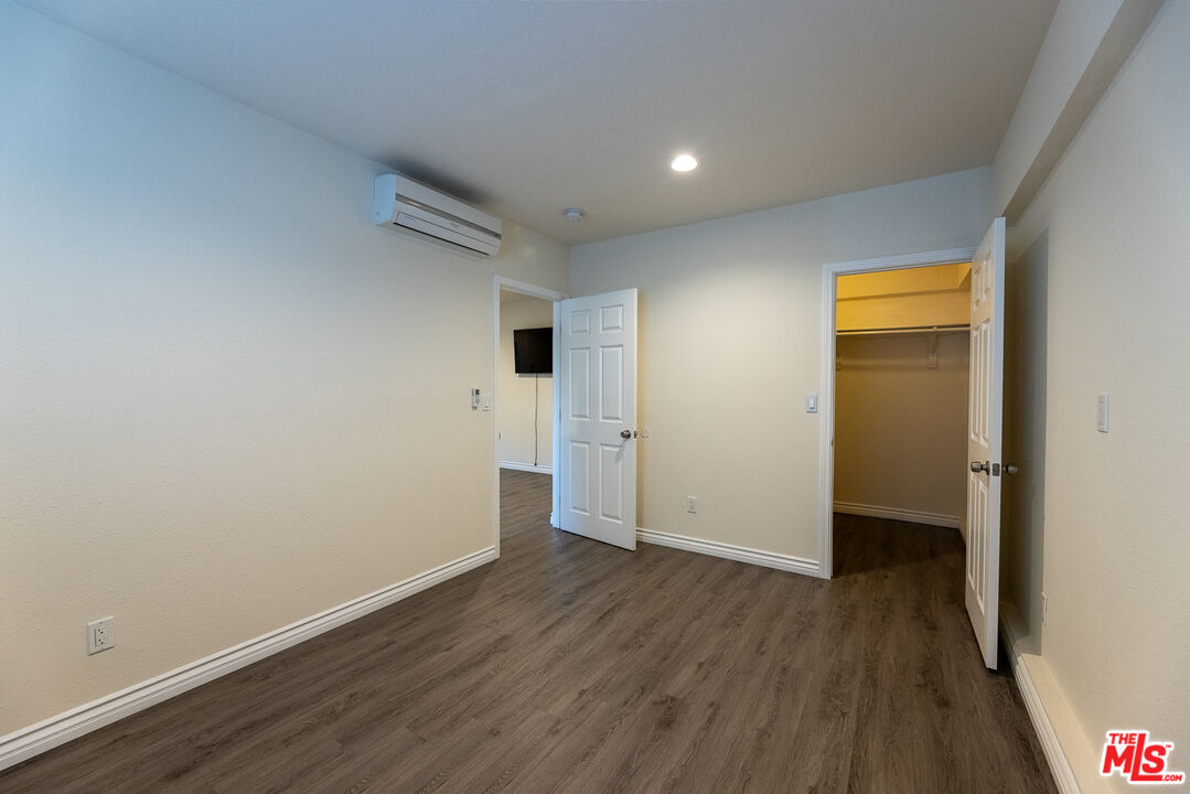 20102 Baltar Street Winnetka, CA 91306 - Photo 11 of 18 a view of an empty room with wooden floor and closet