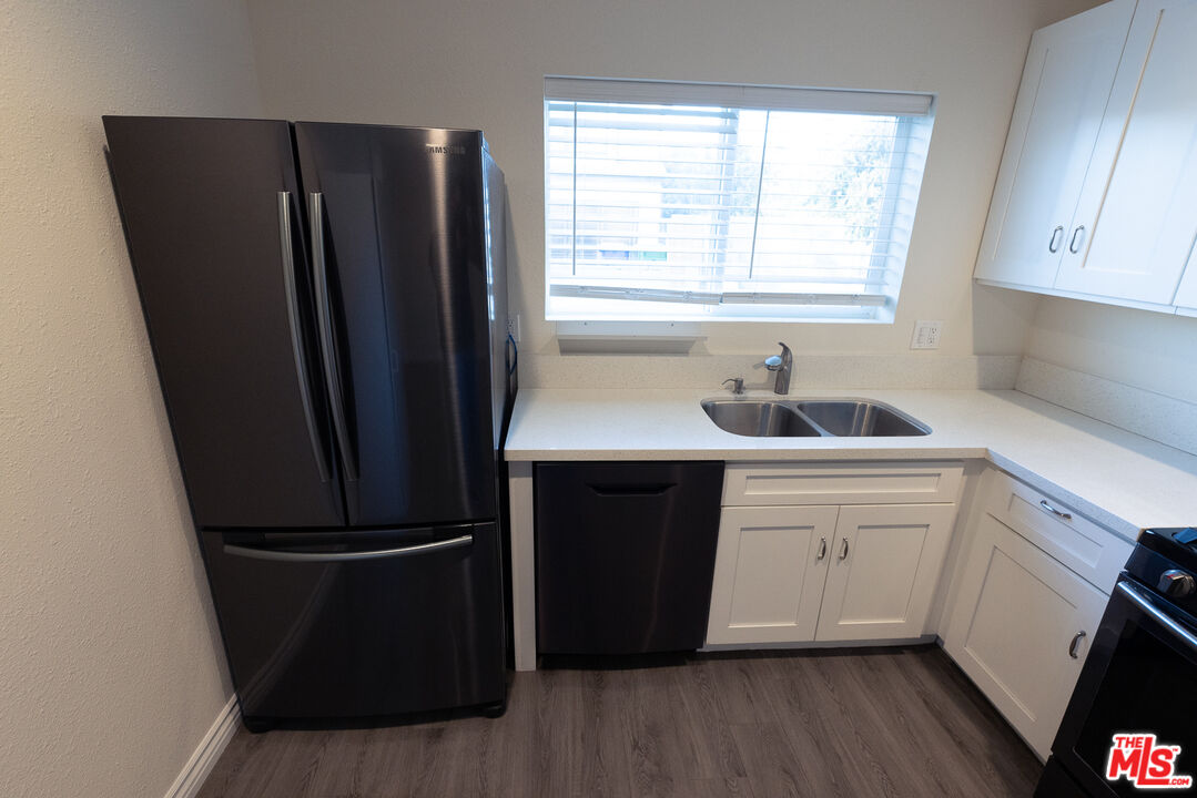 20102 Baltar Street Winnetka, CA 91306 - Photo 15 of 18 a kitchen with a refrigerator and a sink