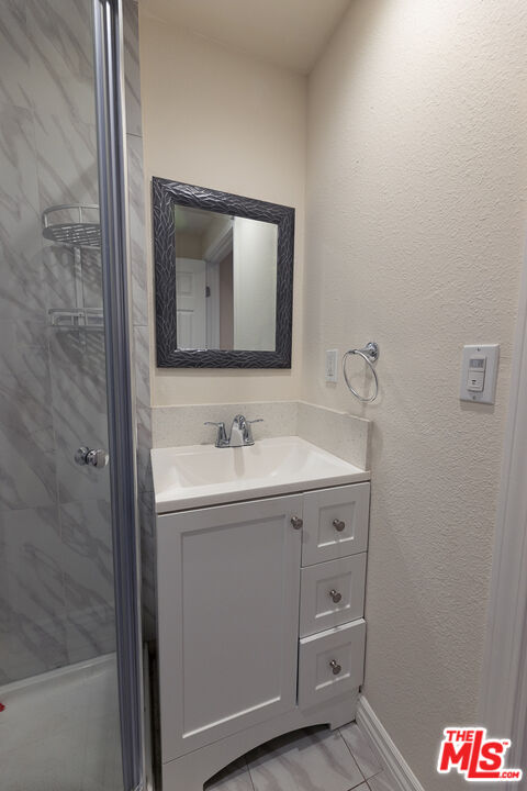 20102 Baltar Street Winnetka, CA 91306 - Photo 17 of 18 a bathroom with a sink and a mirror