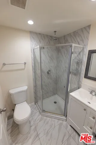 a bathroom with a toilet and a shower