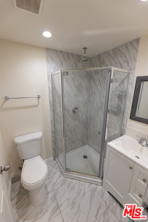 20102 Baltar Street Winnetka, CA 91306 - Photo 18 of 18 a bathroom with a toilet and a shower